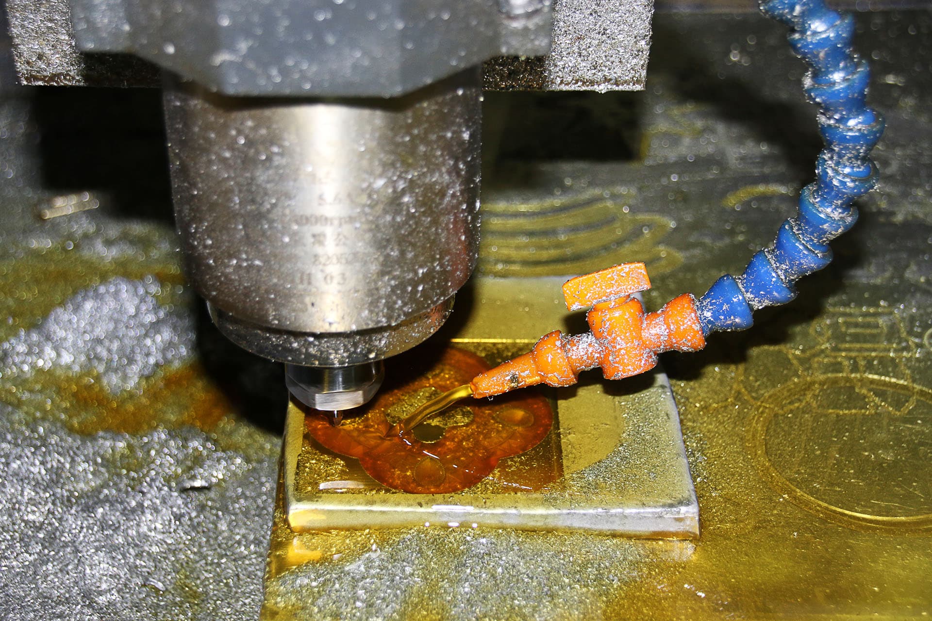 CNC milling in progress — coolant and swarf on a titanium-grade workpiece